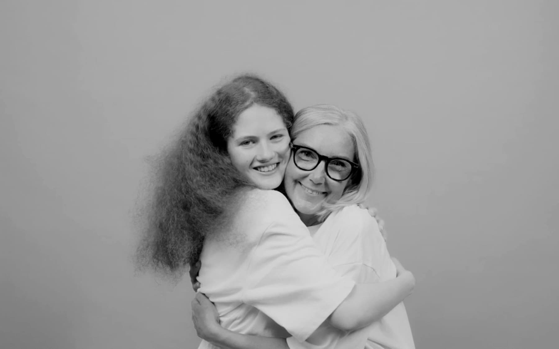 A daughter and mother hugging warmly — the feeling behind gifting a health screening.