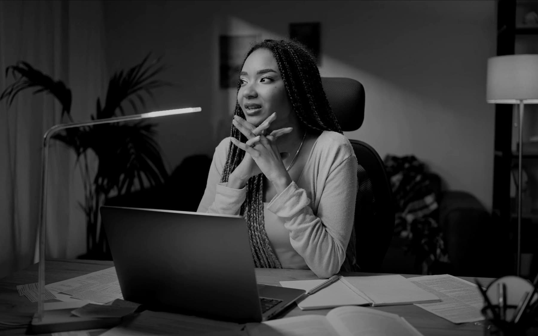 A person at their desk, late at night — the quiet moment before deciding to reach out.